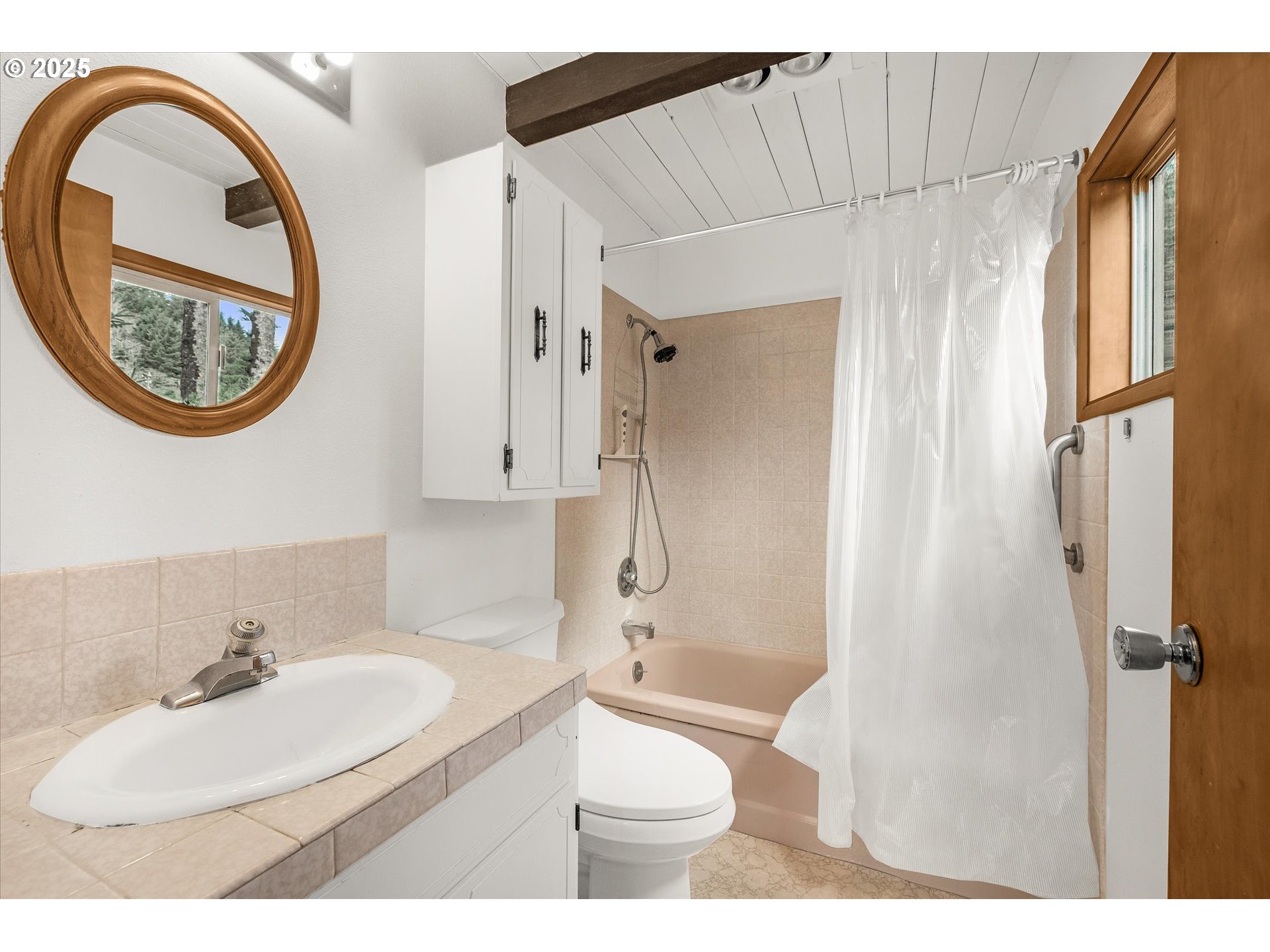 327 Lemwick Lane Yachats, OR 97498 - Photo 26 of 41 a bathroom with a sink a toilet and a mirror