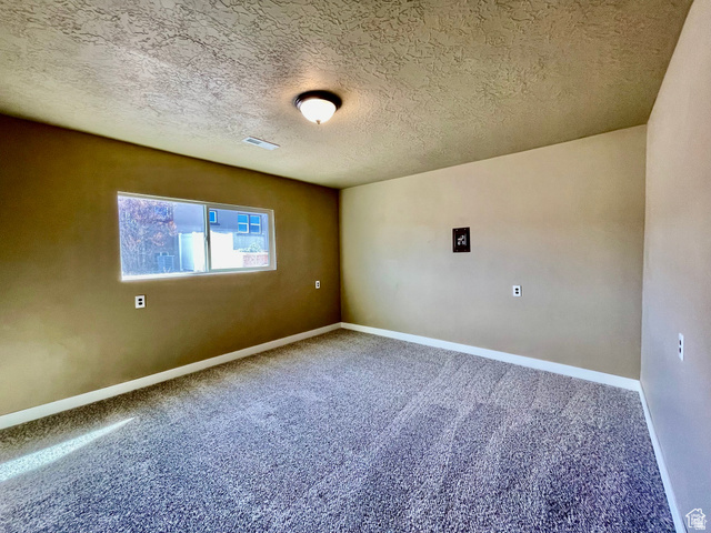 255 West Main Street Mount Pleasant, UT 84647 - Photo 26 of 35 Carpeted room featuring a single window, a ceiling-mounted light fixture, neutral-toned walls, and white baseboards