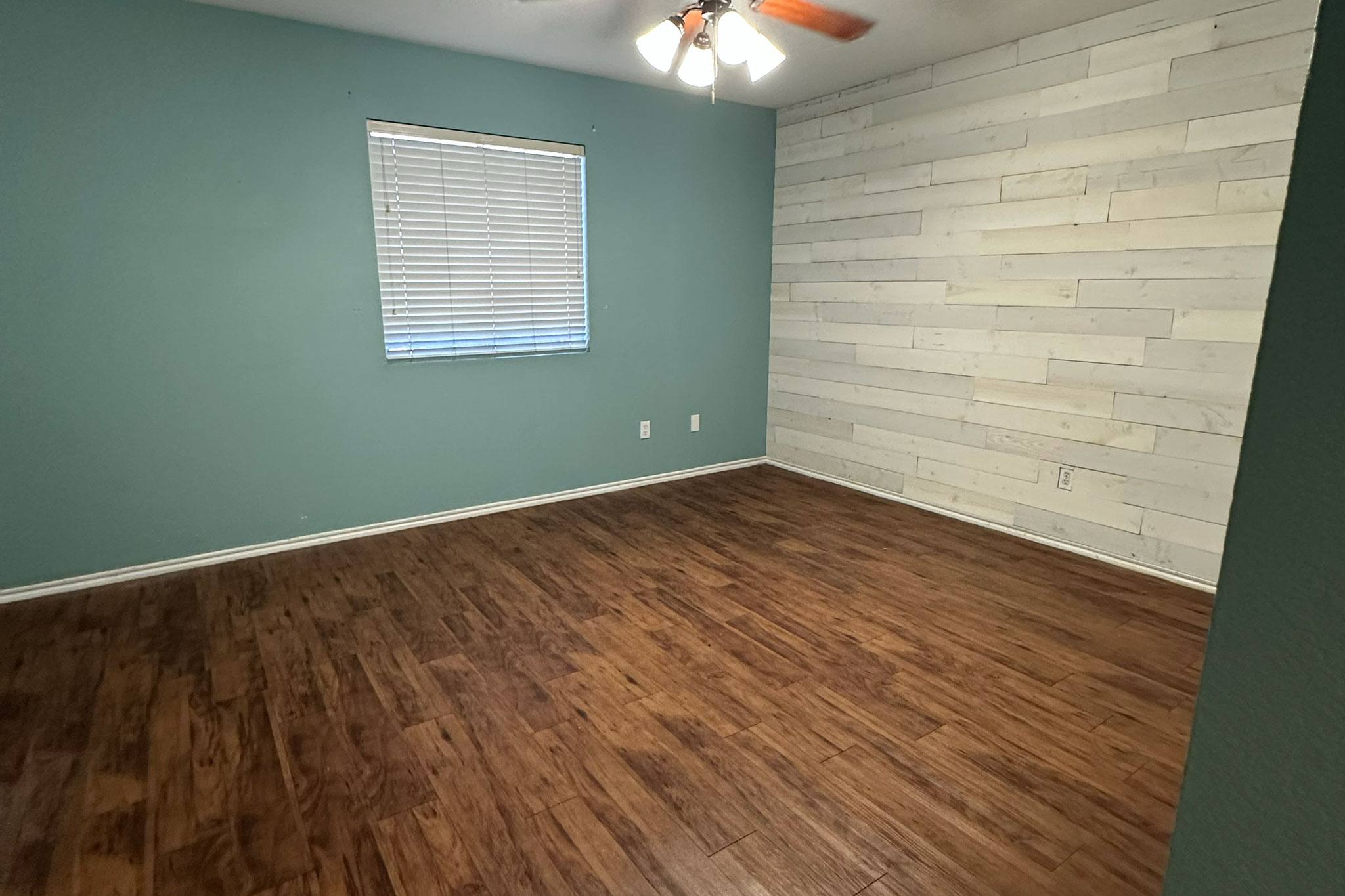 3309 Crownover Street Austin, TX 78725 - Photo 6 of 12 a view of an empty room with wooden floor and a window