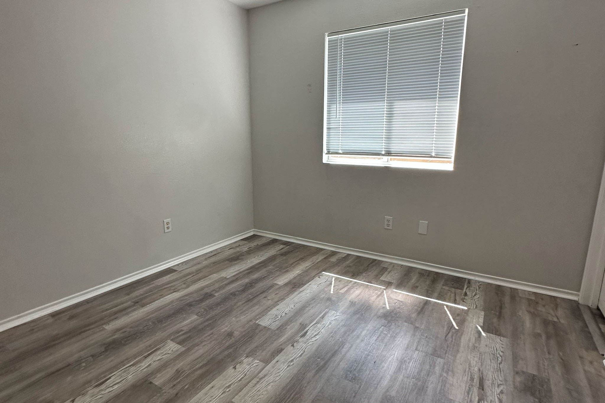 3309 Crownover Street Austin, TX 78725 - Photo 9 of 12 a view of an empty room with wooden floor and a window