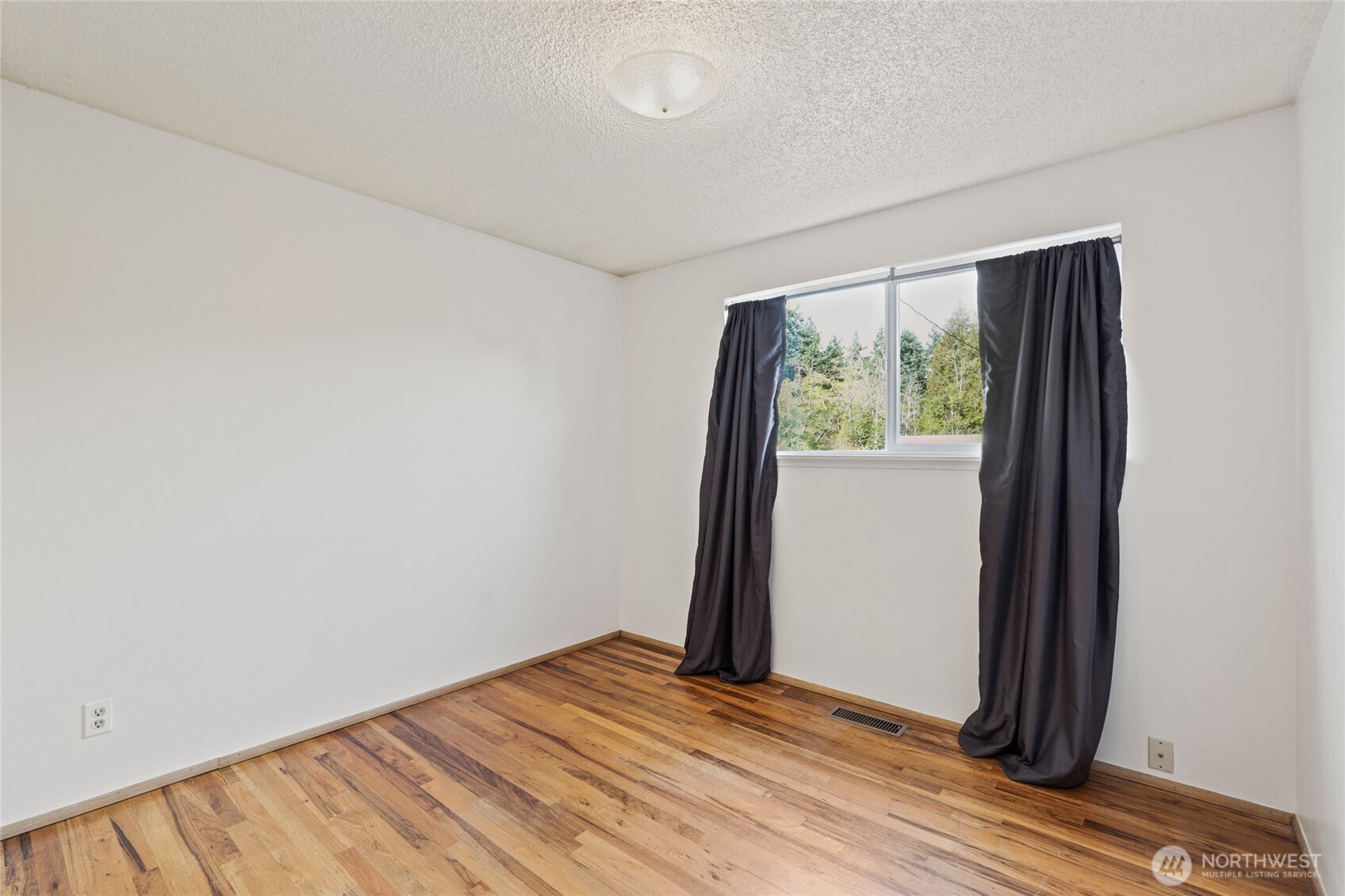 8506 224th Street Southwest Edmonds, WA 98026 - Photo 14 of 19 an empty room with wooden floor and a window