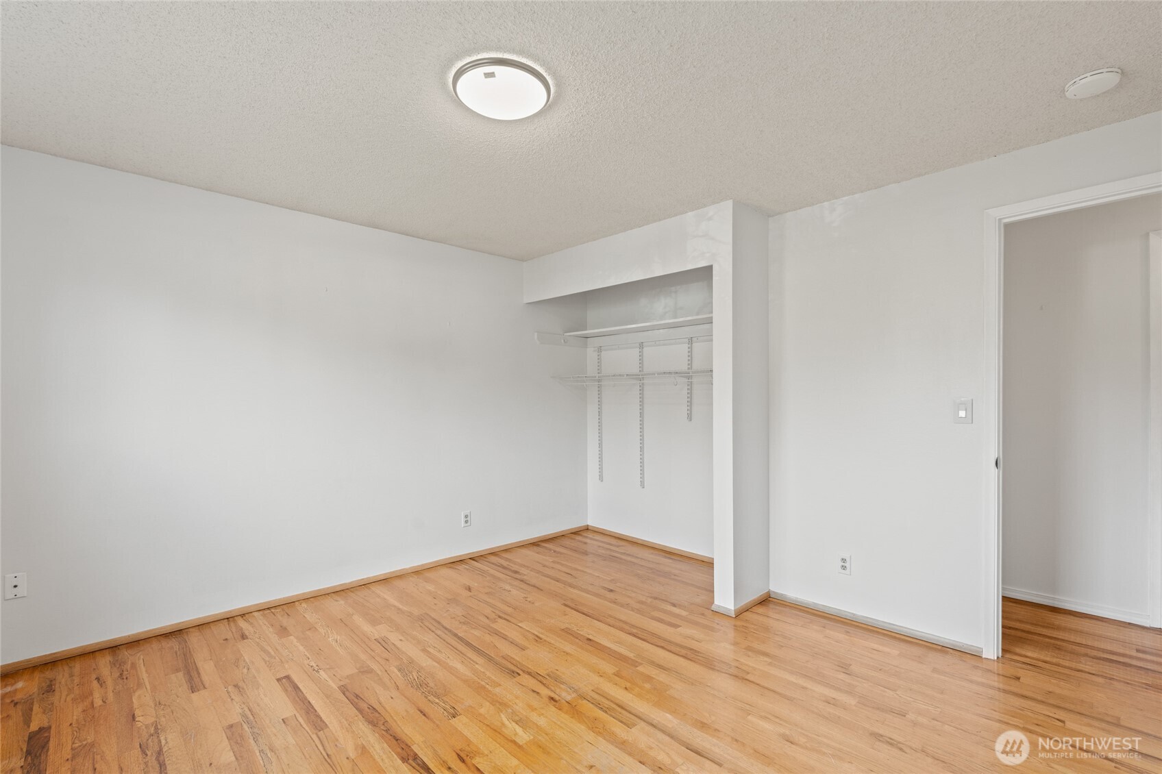 8506 224th Street Southwest Edmonds, WA 98026 - Photo 17 of 19 a view of an empty room with wooden floor and a window