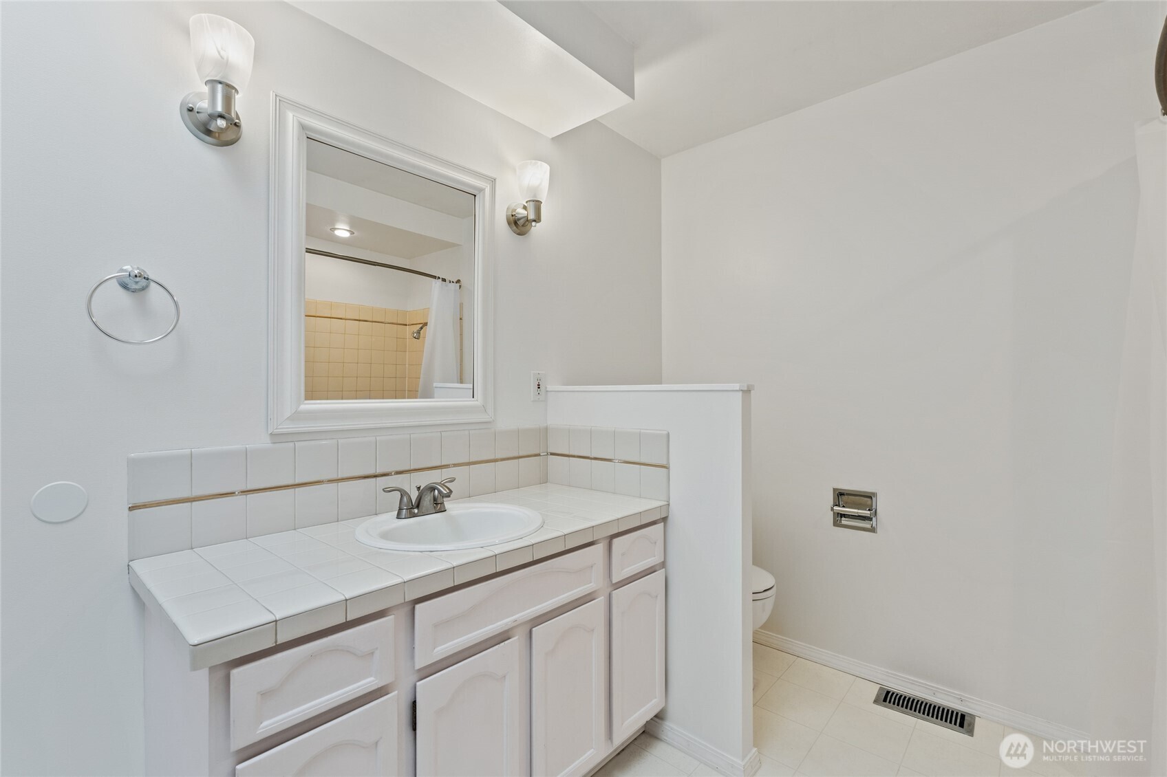 8506 224th Street Southwest Edmonds, WA 98026 - Photo 18 of 19 a bathroom with a sink toilet and mirror