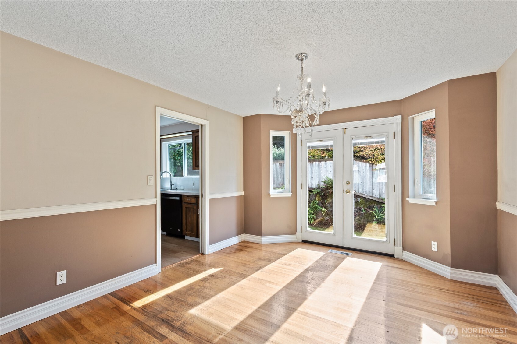 8506 224th Street Southwest Edmonds, WA 98026 - Photo 6 of 19 a spacious bedroom with a bed and a chandelier