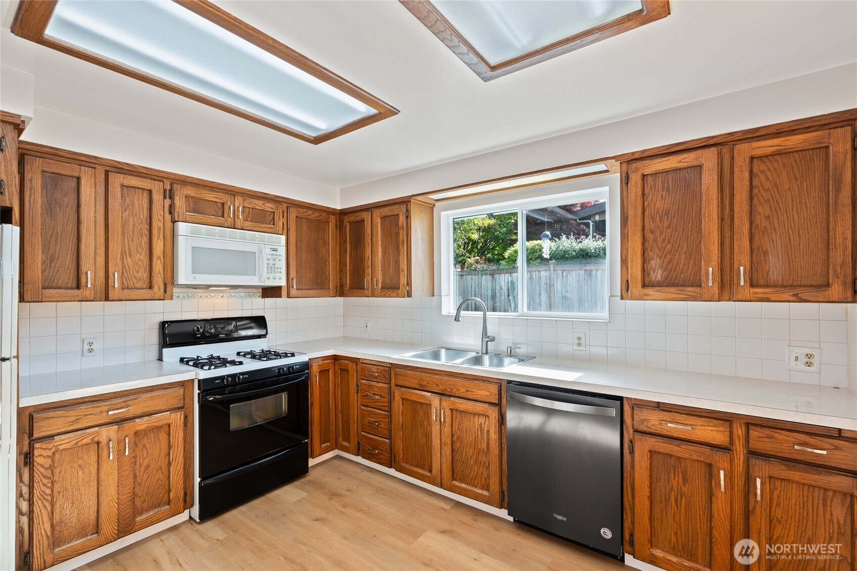 8506 224th Street Southwest Edmonds, WA 98026 - Photo 8 of 19 a kitchen with stainless steel appliances granite countertop a sink stove and refrigerator