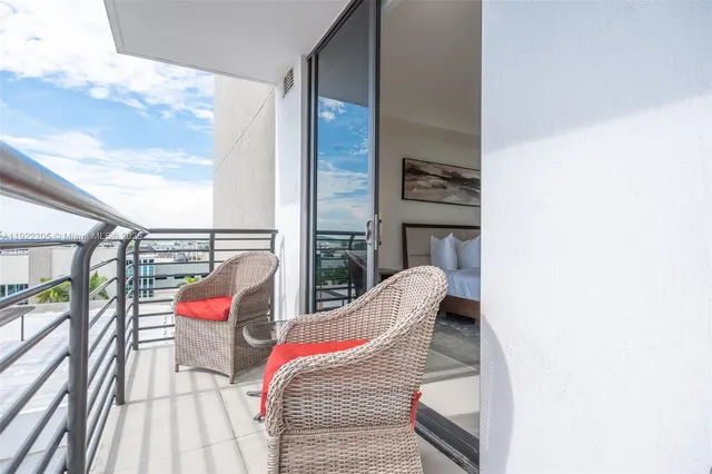 a view of balcony with two chairs and a potted plant