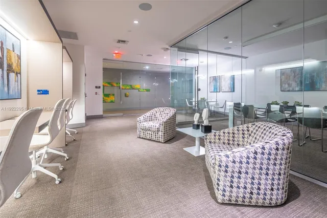 a room with gym equipment and large windows