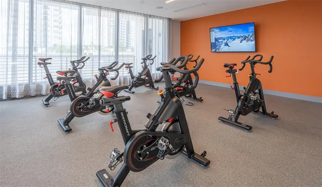 a view of a hallway with wooden floor and a mirror