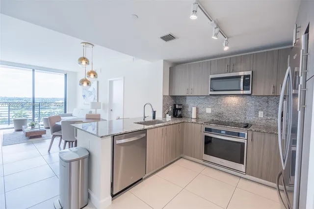 a kitchen with a sink stove and microwave