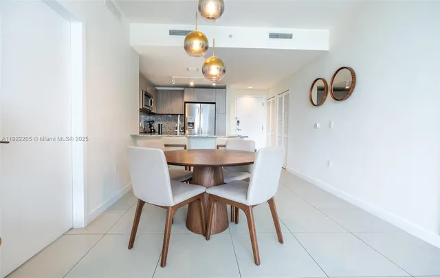 a kitchen with a dining table and chairs
