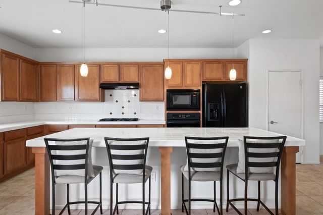 a kitchen with a table chairs refrigerator and microwave