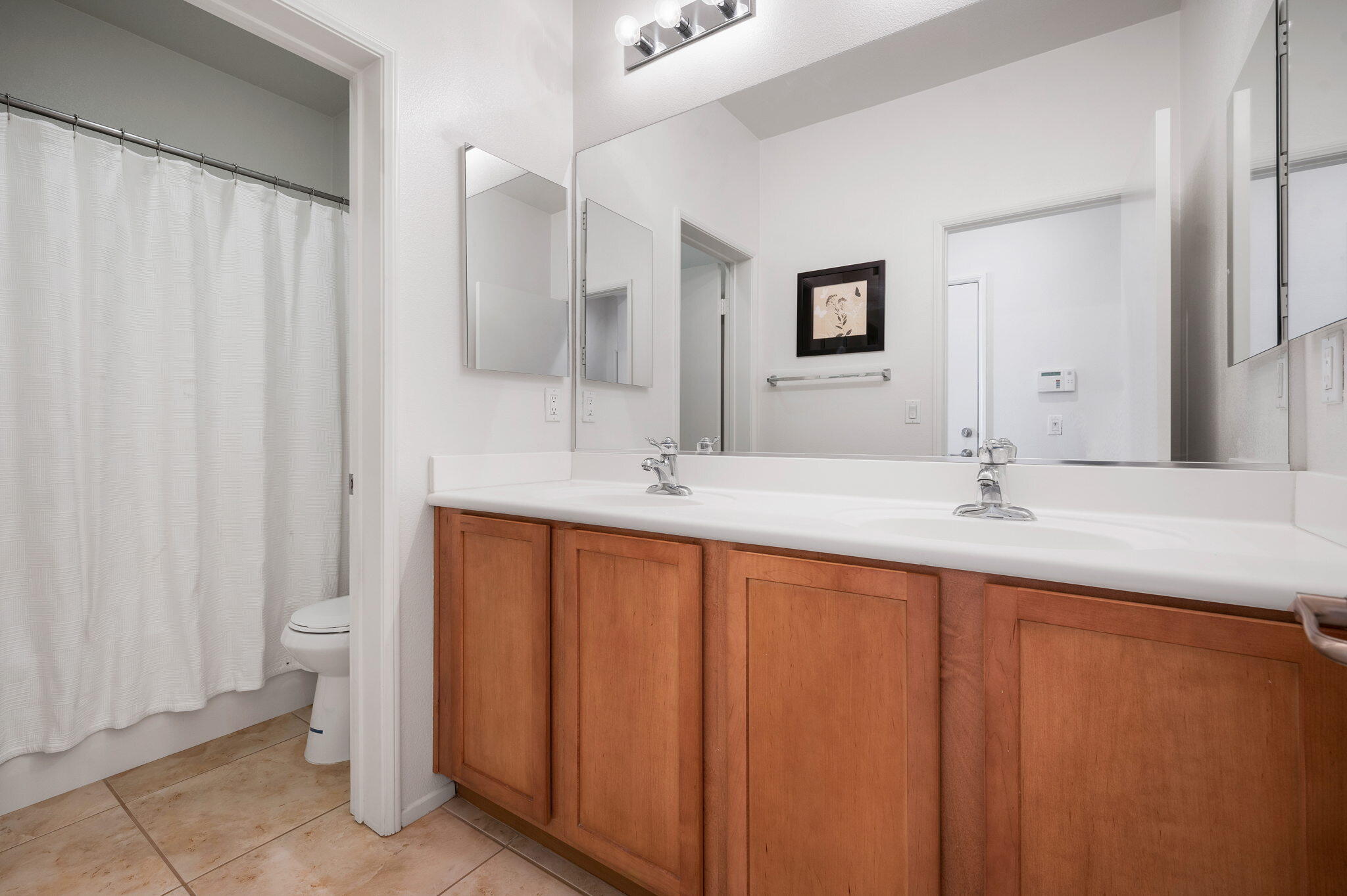 82809 Larsen Drive Indio, CA 92203 - Photo 17 of 34 a bathroom with a double vanity sink and a mirror