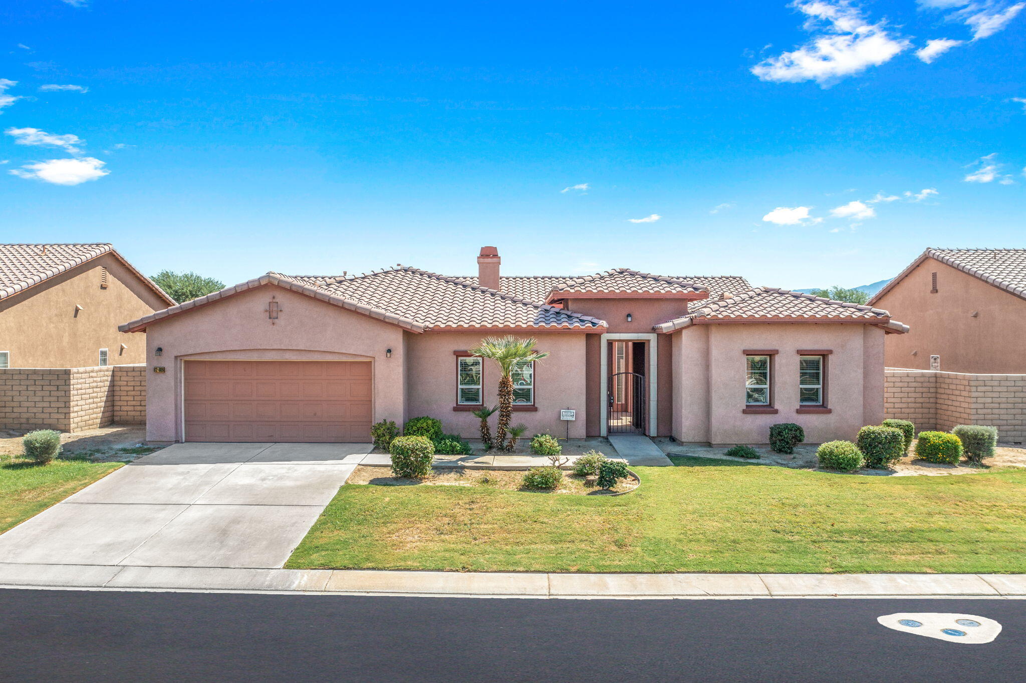 82809 Larsen Drive Indio, CA 92203 - Photo 2 of 34 a front view of a house with a yard and garage