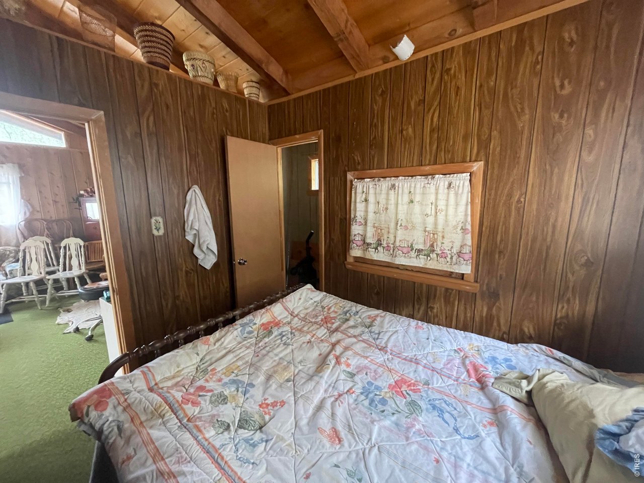 509 Riverside Drive Lyons, CO 80540 - Photo 15 of 15 a bedroom with a bed and a window