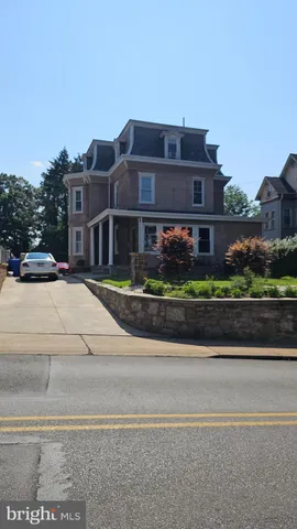 a front view of a residential apartment building with a yard