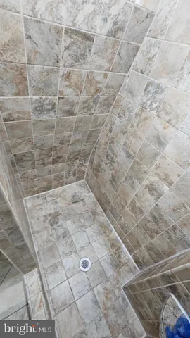 a view of a swimming pool in a yard with large trees