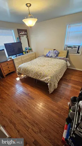 a view of a house with a big yard and large trees