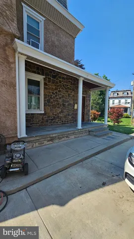 a view of a livingroom with furniture and staircase