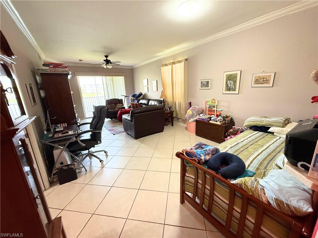 8490 Kingbird Loop, Unit 930 Estero, FL 33967 - Photo 2 of 12 Living room with crown molding, light tile patterned floors, and ceiling fan