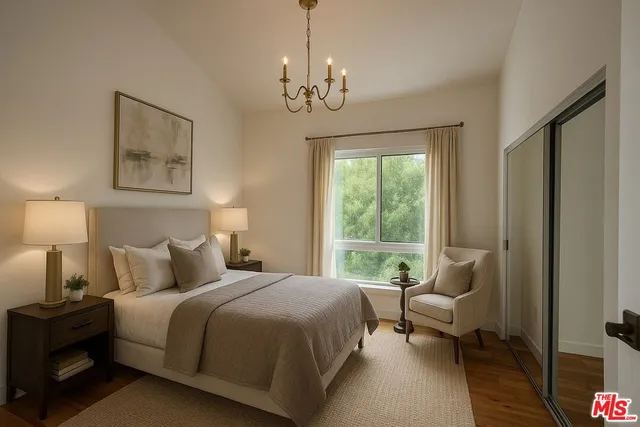 a bedroom with bed and a chandelier