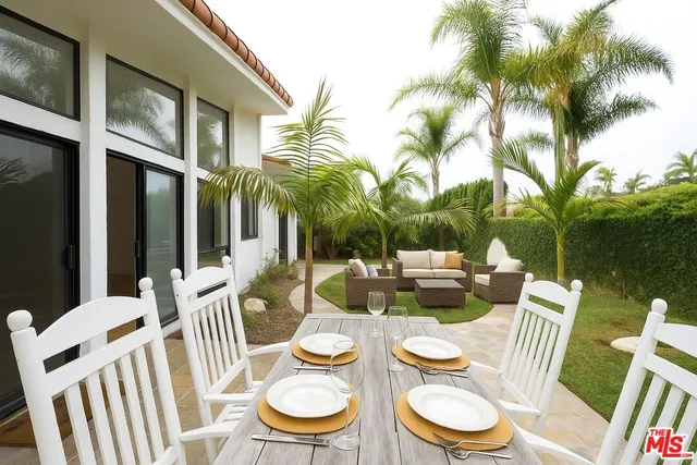 a table and chairs in front of a house