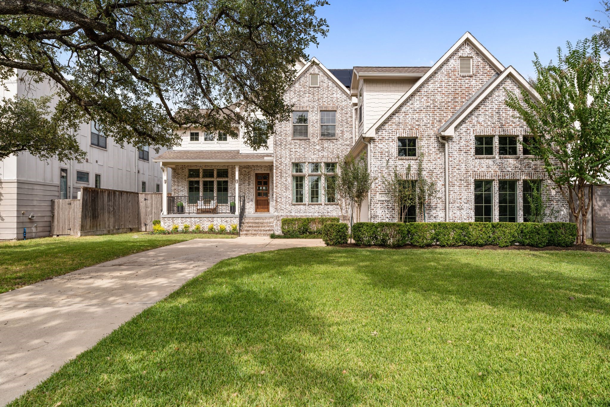 a front view of a house with a yard and green space