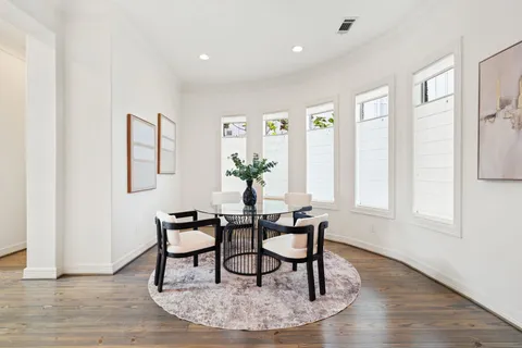 a dining room with furniture and wooden floor