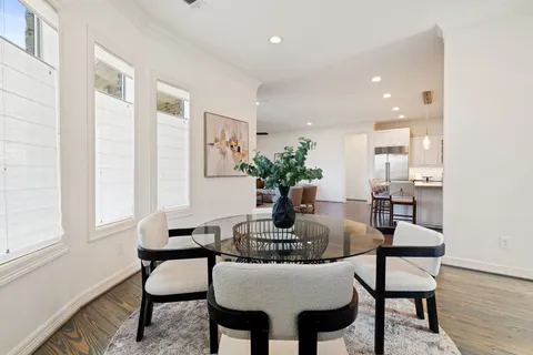 a dining room with furniture and wooden floor