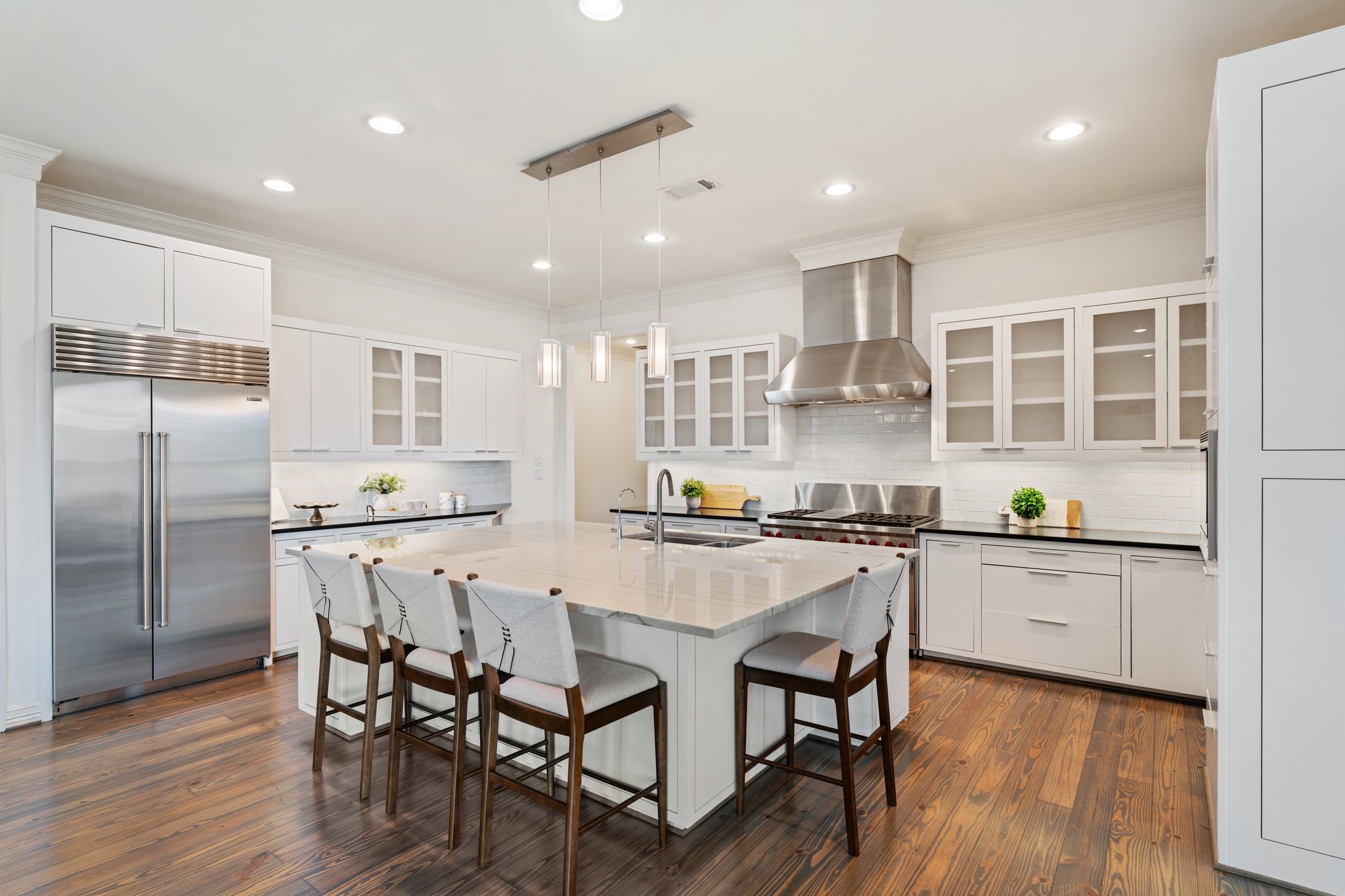 4822 Jason Street Houston, TX 77096 - Photo 20 of 45 a kitchen with stainless steel appliances granite countertop a stove top oven a sink dishwasher and a refrigerator with wooden floor