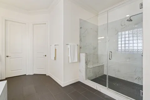 a bathroom with a glass shower door