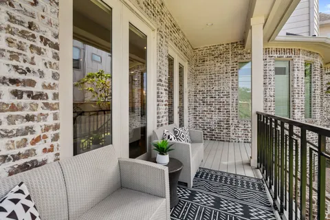 a view of a balcony with wooden floor