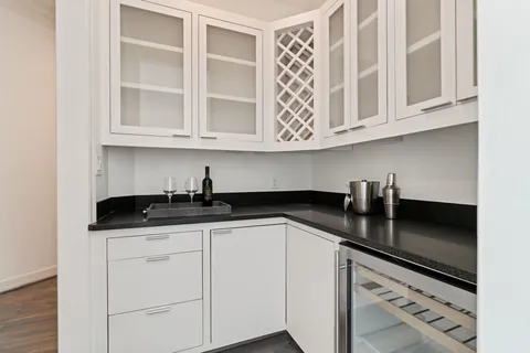 a kitchen with granite countertop a sink and cabinets