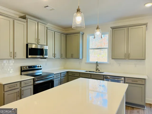 a kitchen with a sink a stove and cabinets