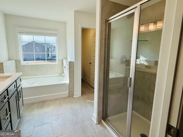 a bathroom with a tub and shower