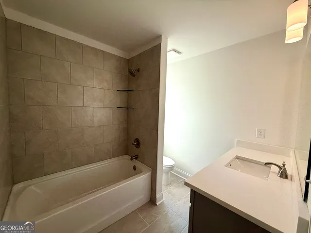 a bathroom with a bathtub and a sink