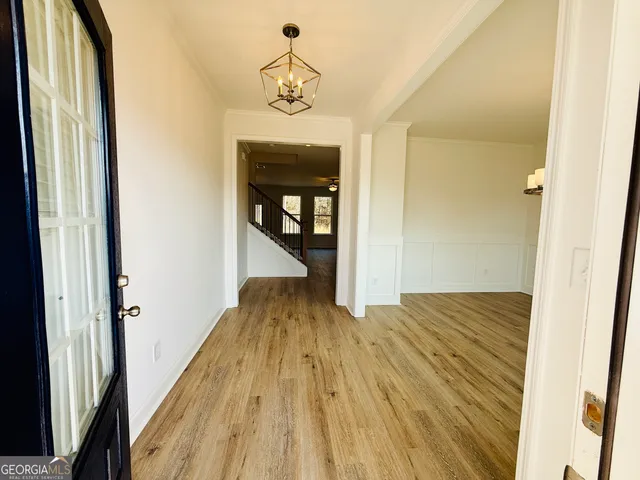 a view of a hallway view with wooden floor and staircase