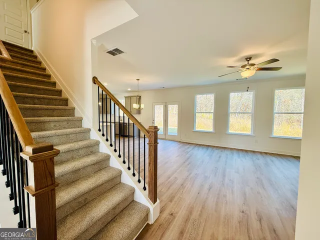 a view of an entryway with wooden floor and stairs
