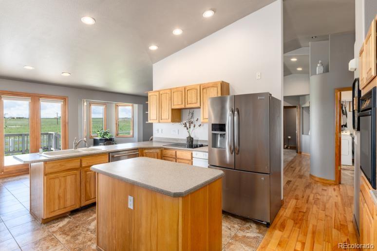 25876 County Road 5 Elbert, CO 80106 - Photo 11 of 43 a kitchen with stainless steel appliances granite countertop a refrigerator a sink and a stove