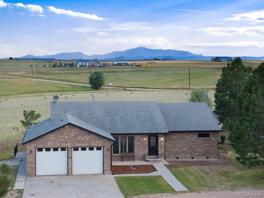 25876 County Road 5 Elbert, CO 80106 - Photo 2 of 43 a front view of a house with a garden and lake view