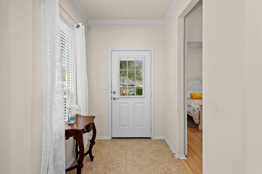 109 Providence Street Georgetown, TX 78633 - Photo 6 of 31 Entryway featuring light-toned tile flooring, a white paneled door with window inserts, and crown molding
