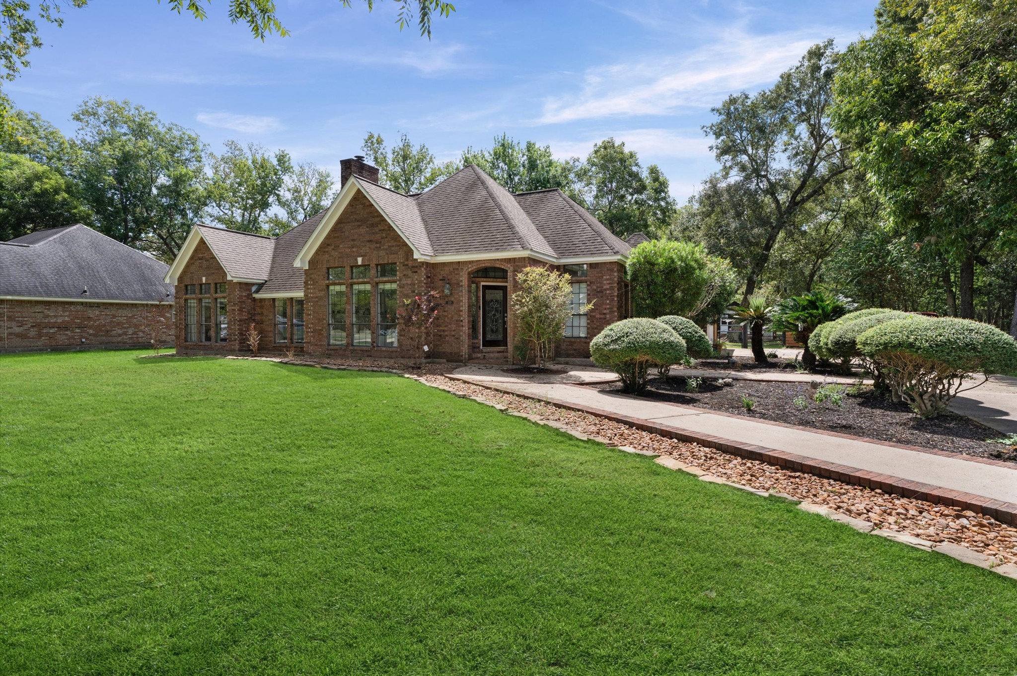 Pretty landscaping lines the sidewalk, creating a charming little path that welcomes you home !