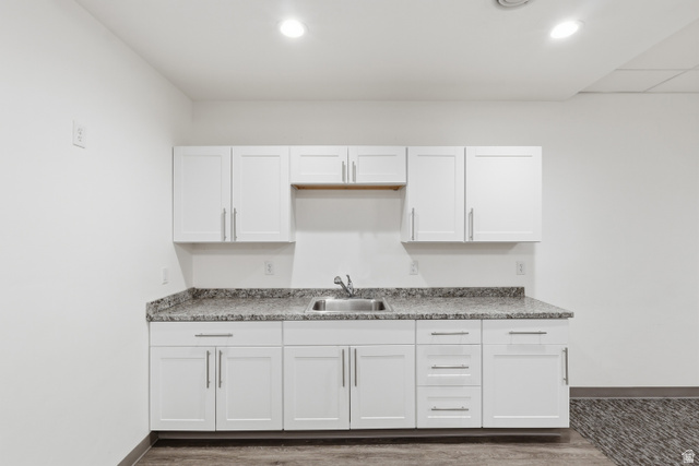 2085 North Main Street, Unit 409 Sunset, UT 84015 - Photo 11 of 17 Club room with kitchen with white cabinets and dark wood finished floors