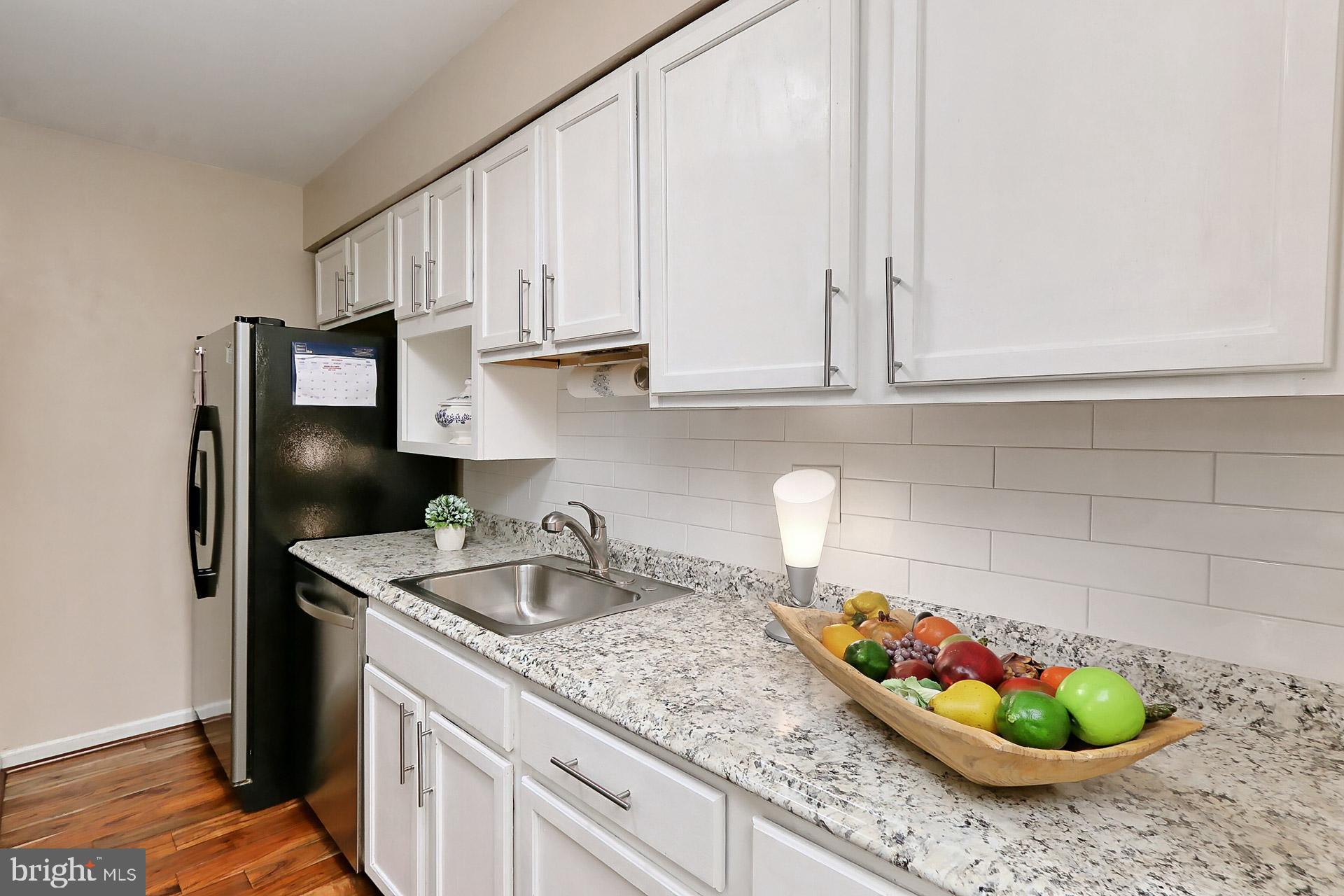 5907 D Noblestown Road, Unit 66 Springfield, VA 22152 - Photo 15 of 53 Kitchen has white cabinets & stainless appliances