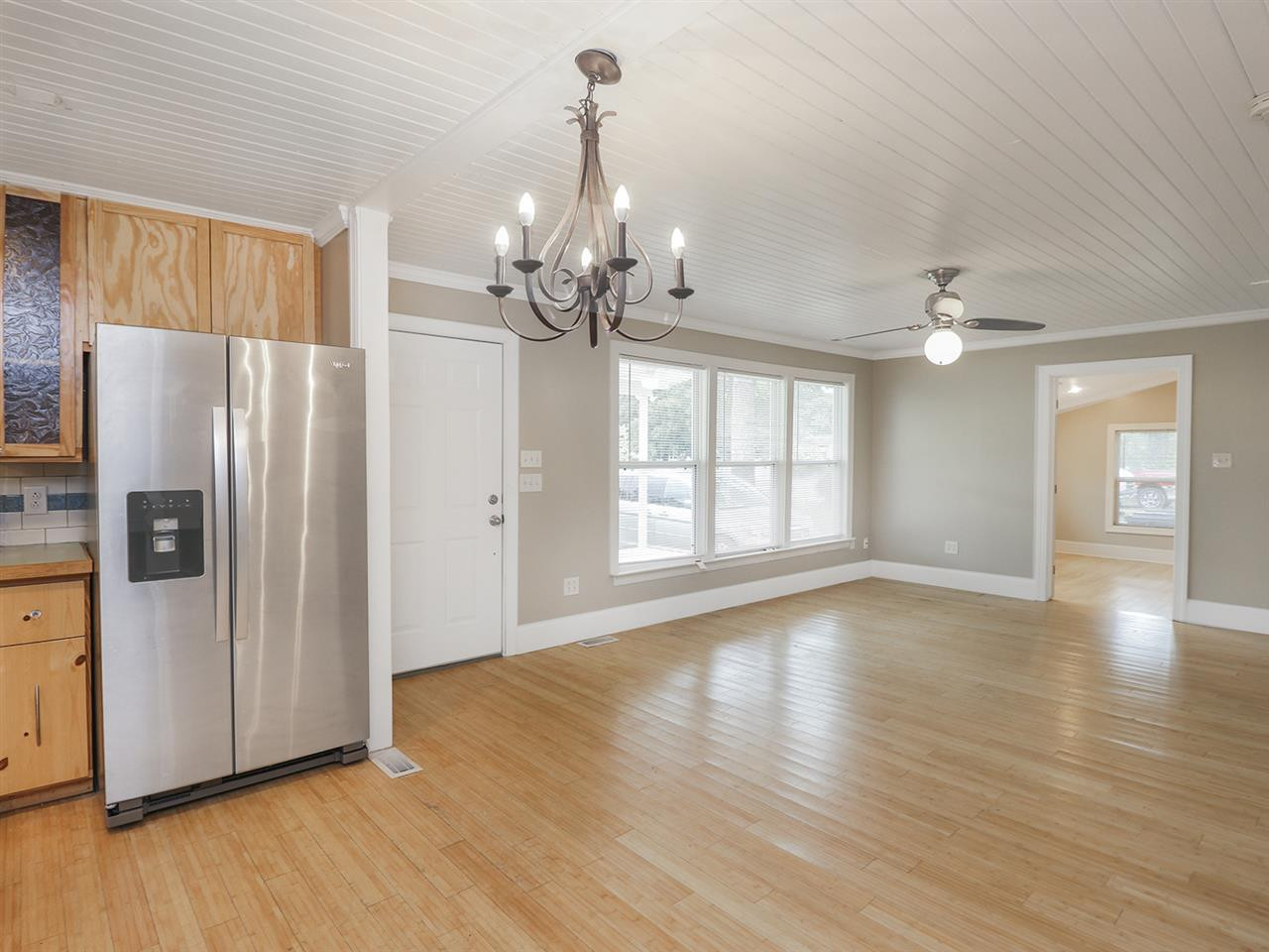 204 Proctor Street Zebulon, NC 27597 - Photo 11 of 30 a view of a livingroom with wooden floor and a kitchen space