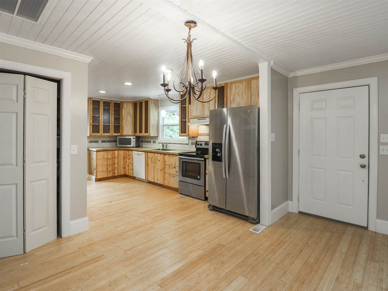 204 Proctor Street Zebulon, NC 27597 - Photo 13 of 30 a kitchen with stainless steel appliances granite countertop a refrigerator oven a sink and dishwasher