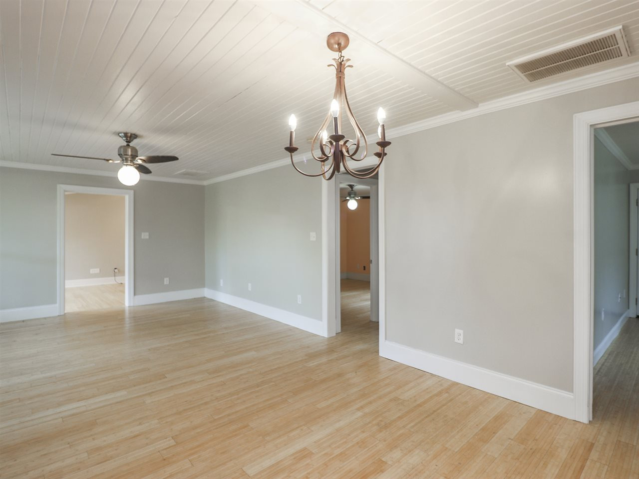 204 Proctor Street Zebulon, NC 27597 - Photo 14 of 30 a view of a room with wooden floor window and a chandelier