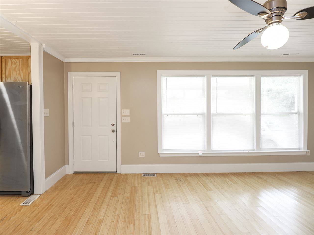 204 Proctor Street Zebulon, NC 27597 - Photo 15 of 30 an empty room with wooden floor and windows