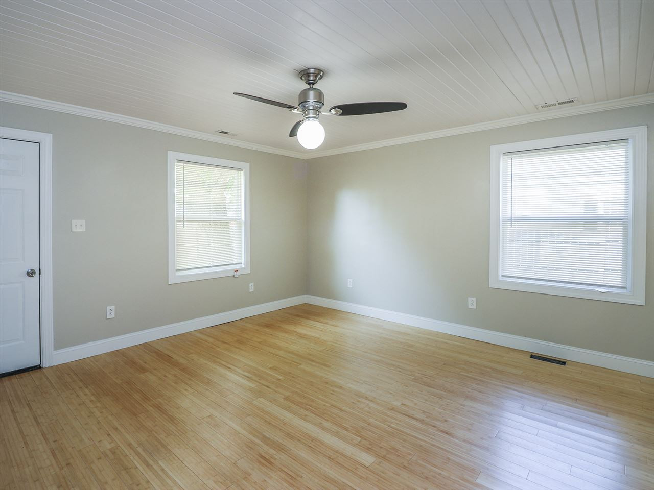 204 Proctor Street Zebulon, NC 27597 - Photo 22 of 30 a view of an empty room with wooden floor and a window