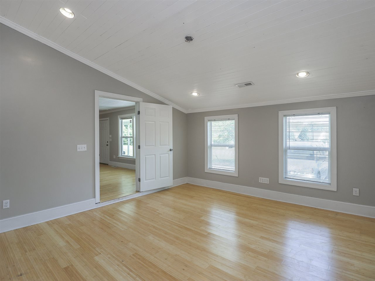 204 Proctor Street Zebulon, NC 27597 - Photo 24 of 30 an empty room with wooden floor and windows