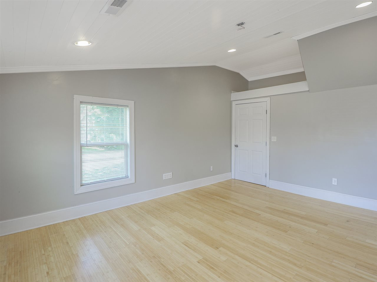 204 Proctor Street Zebulon, NC 27597 - Photo 25 of 30 wooden floor in an empty room with a window